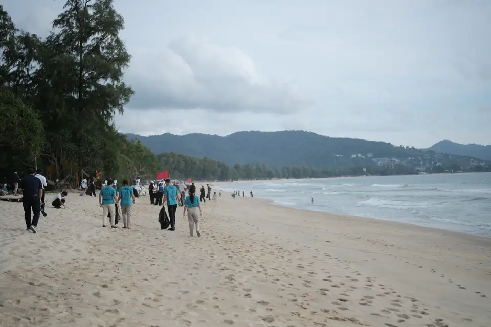 Volunteers walking along Layan Beach during the clean-up