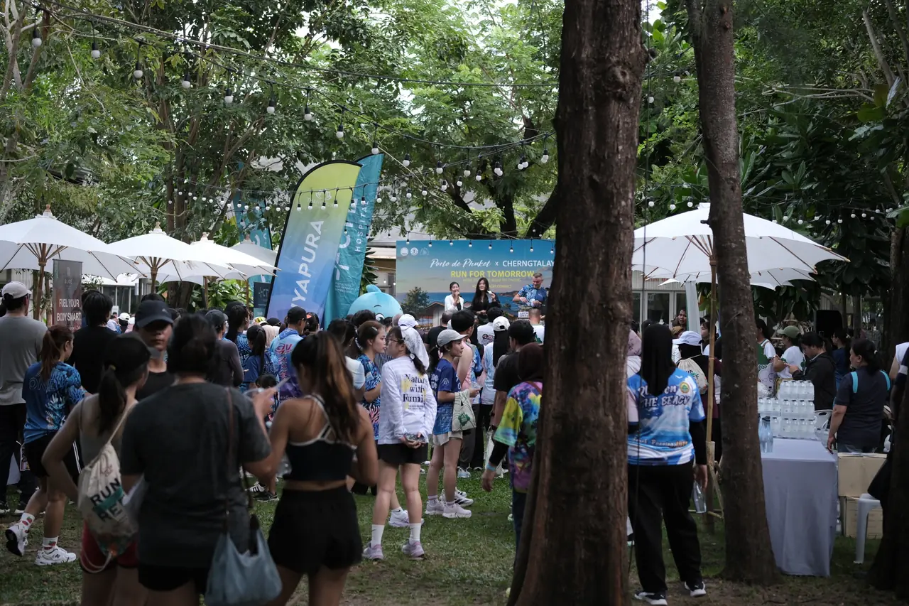 Runners gathering in the event area at Porto de Phuket under white umbrellas