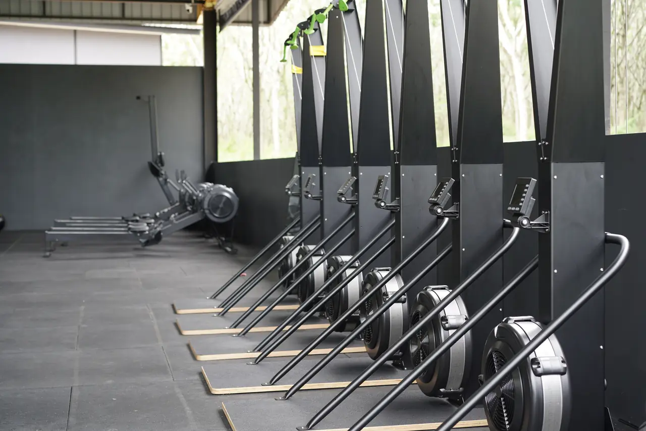 Rows of SkiErg machines stand ready along the side of the Khunpon fitness floor