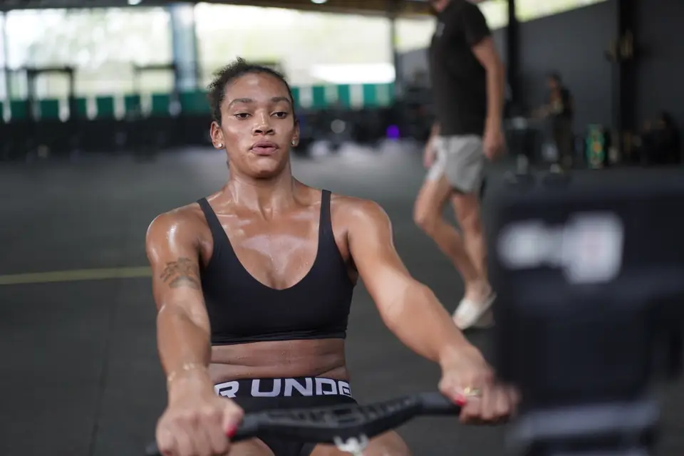 A woman rows at full effort