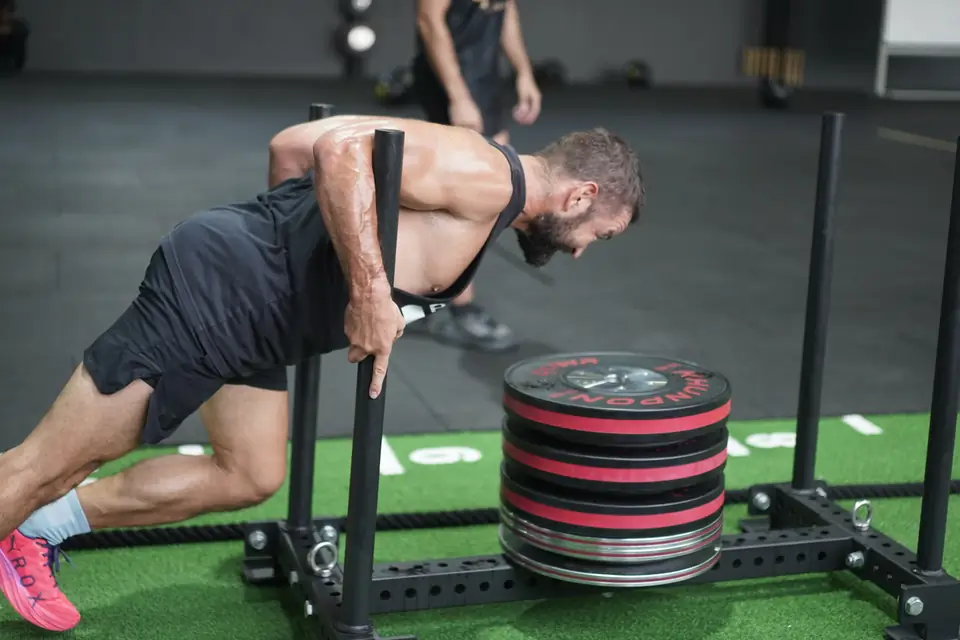 A man pushes the sled with his head down