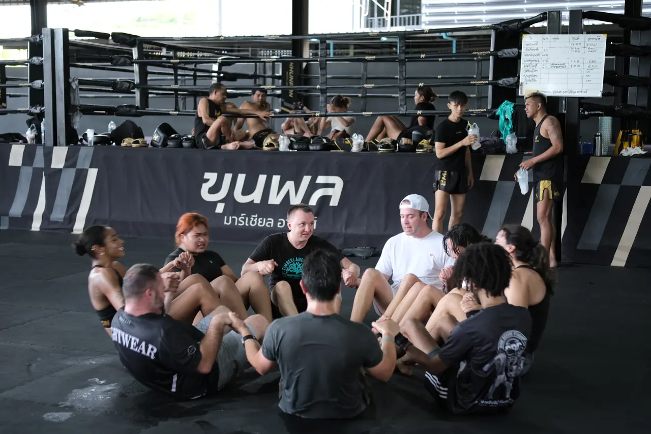 Students finish the class with conditioning in a circle on the mats