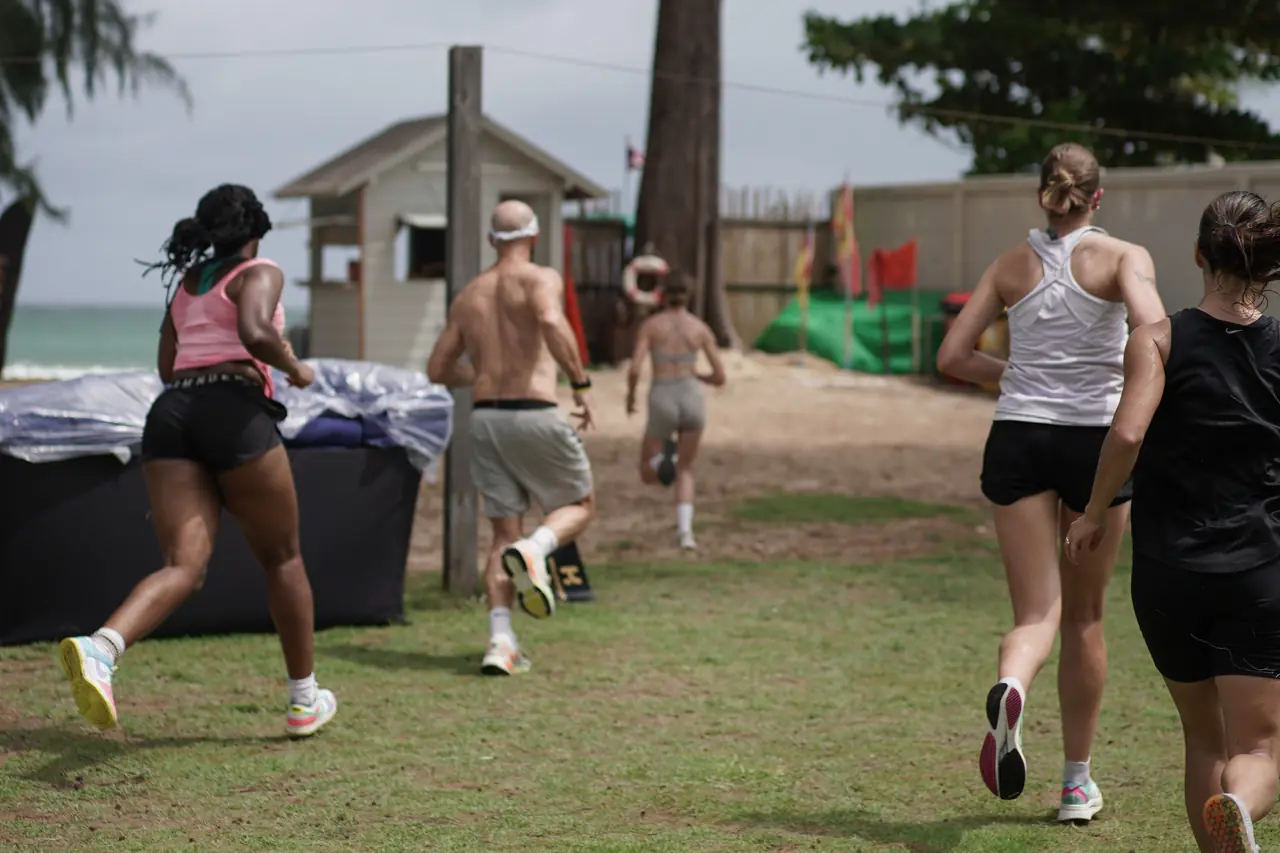 Runners head through the trees towards Bang Tao Beach on the relay leg