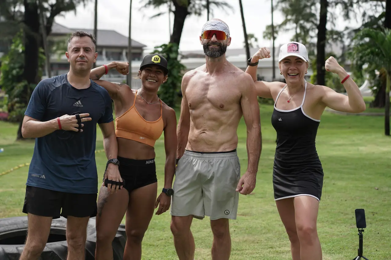 A team of four flex for the camera after finishing