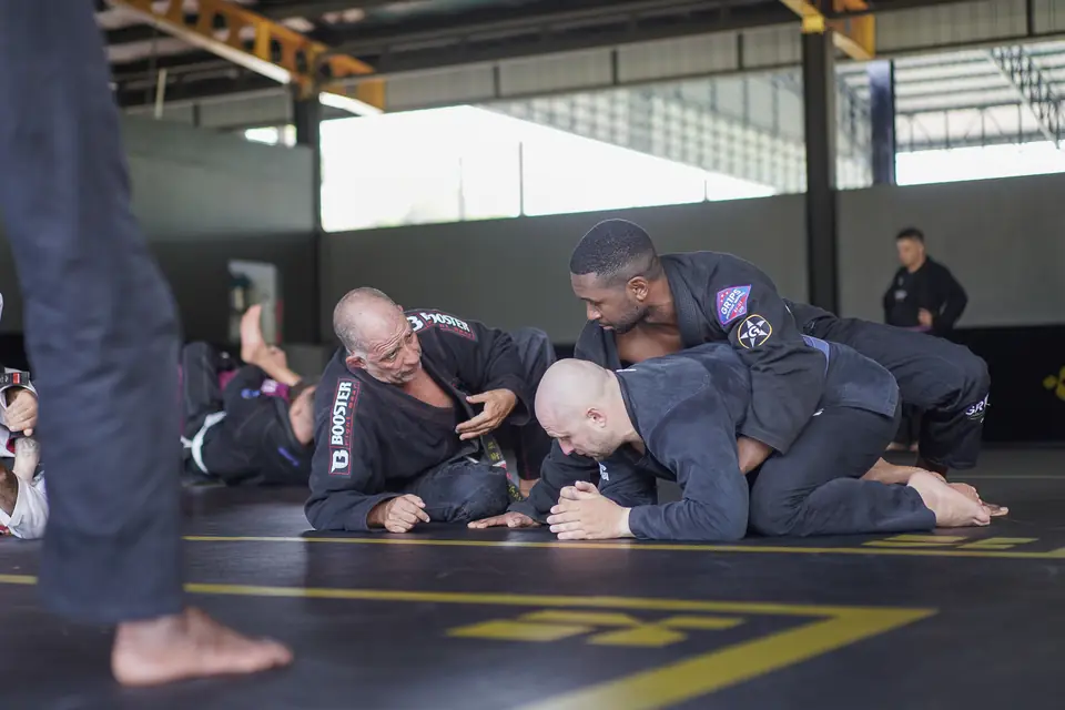 The Professor coaches two students through a top position