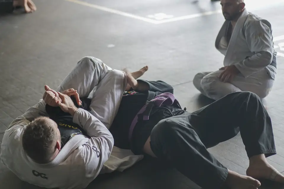 A close view of two practitioners drilling a guard position