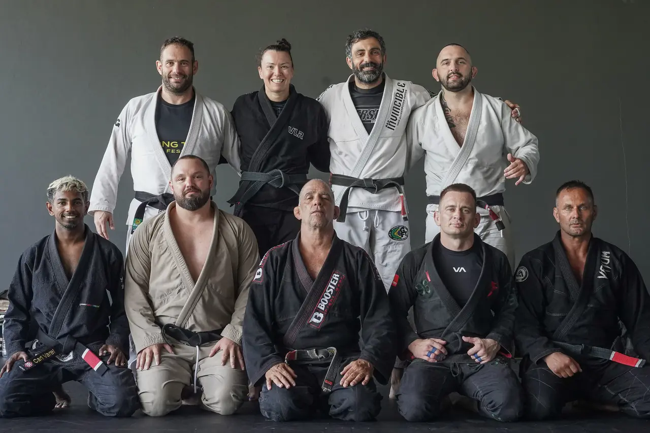 The Professor with Khunpon's instructors and black belts, kneeling in a group for the camera