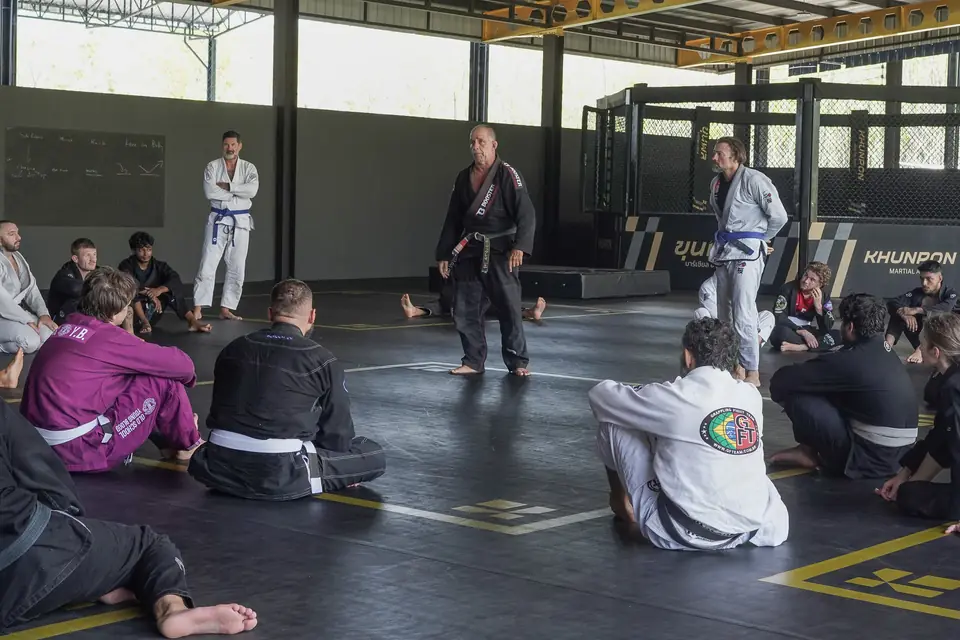 Practitioners rest between drills as the Professor watches from the centre
