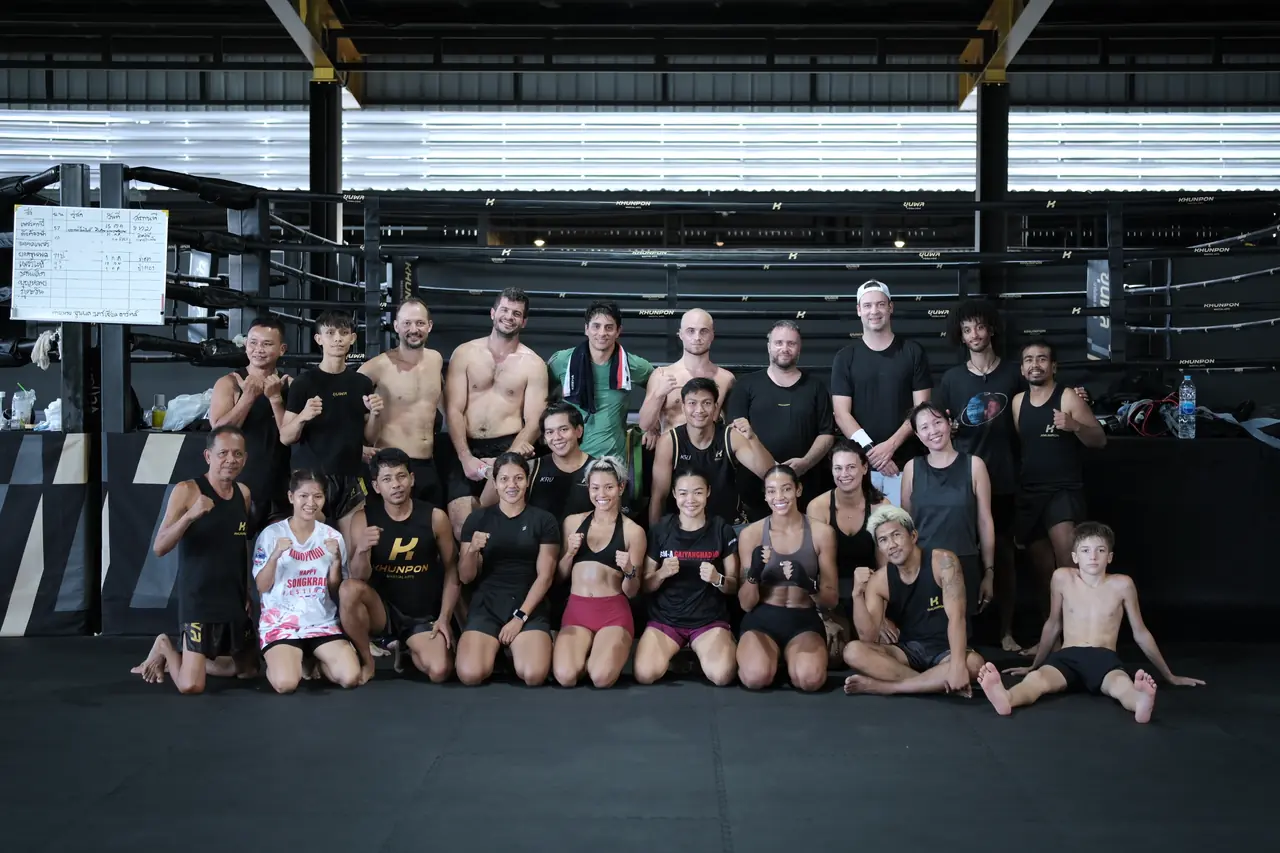 The Khunpon community gathers for a big group photo on the Muay Thai floor