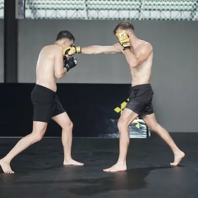 Two fighters trade punches in MMA gloves