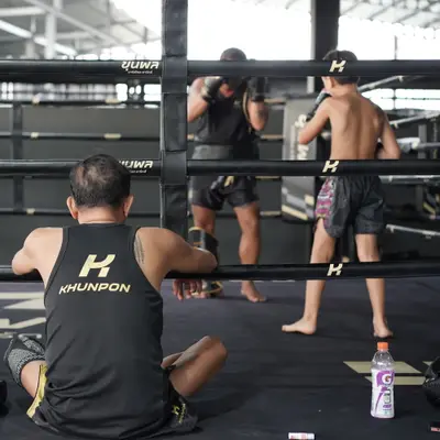 A trainer watches fighters work in the Muay Thai ring