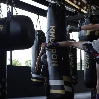 A roundhouse kick on the heavy bag in the Muay Thai bag area