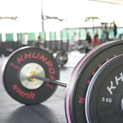 Khunpon bumper plates on a barbell, close up
