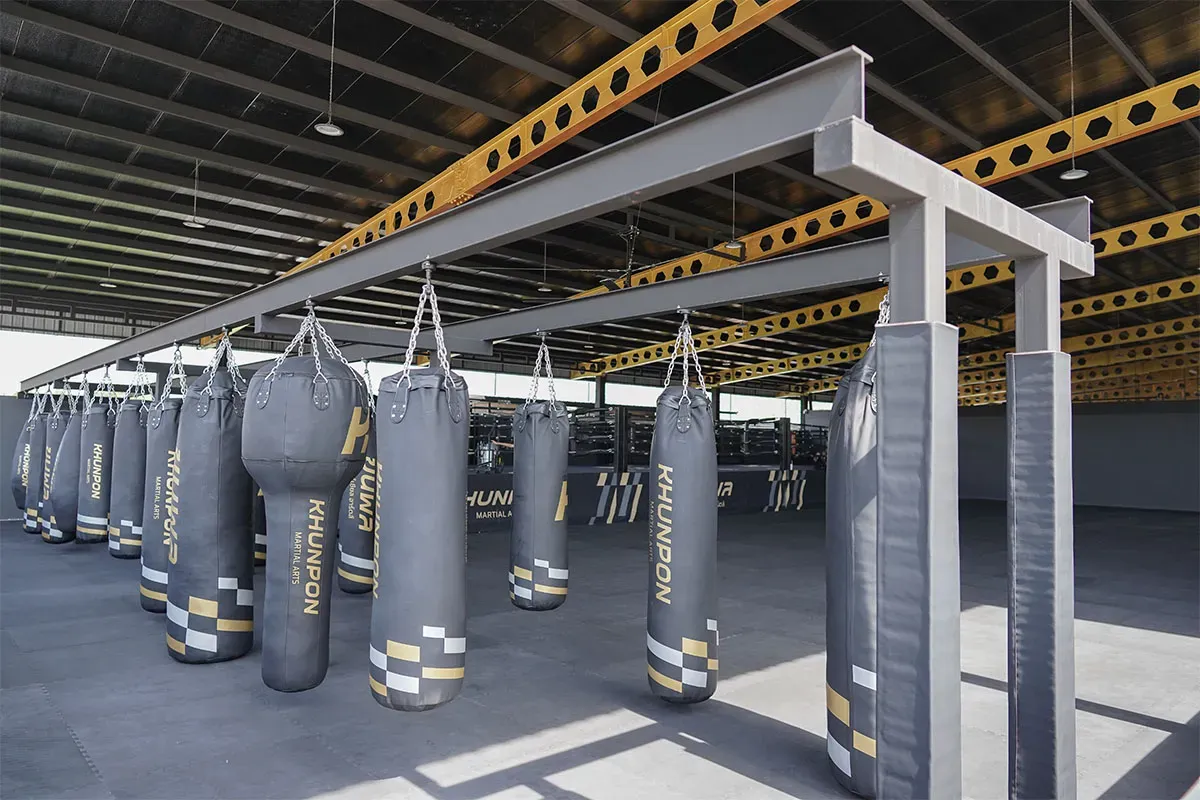 Row of heavy bags at Khunpon Martial Arts