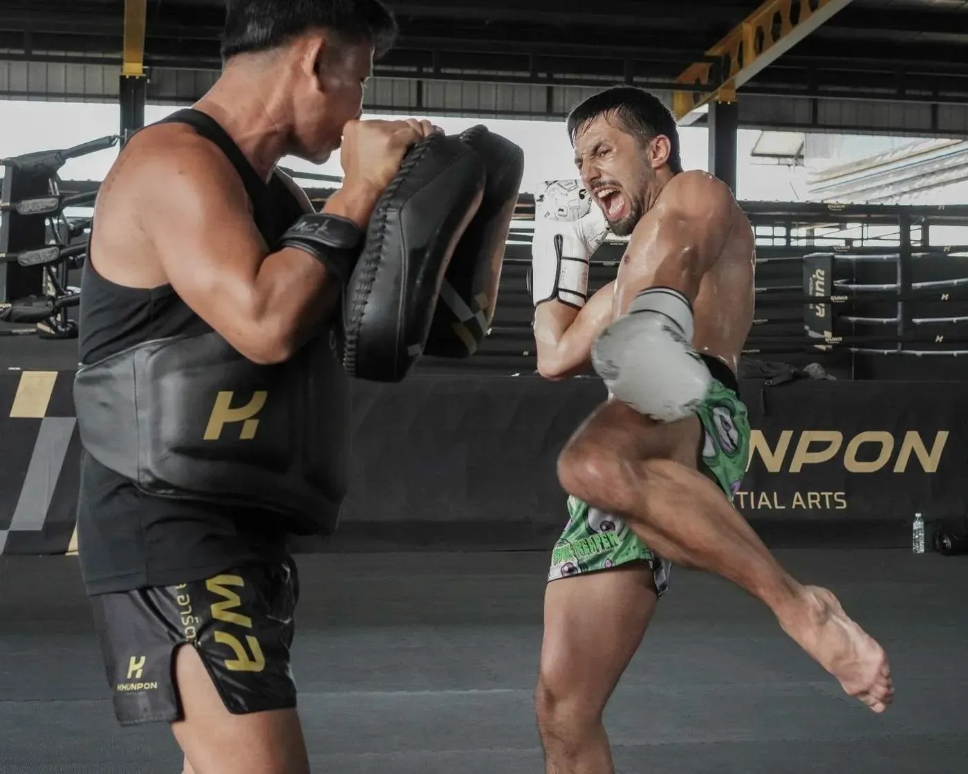 Knee strike on the belly pad during Muay Thai pad work
